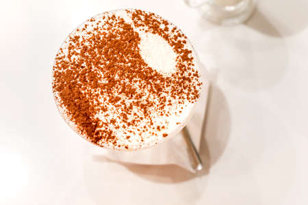 Traditional Italian dessert tiramisu in a glass. top view.