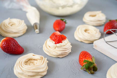 Meringues Pavlova cakes with strawberry top view