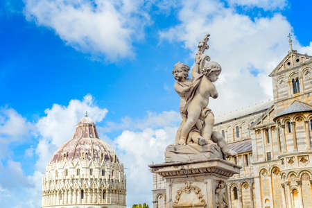 Marble statue in front of the Leaning Tower of Pisa in Piazza dei Miracoli Square of Miracles , Tuscany, Italyの写真素材