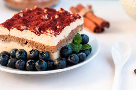 Piece of appetizing tiramisu cake on plate in close upの写真素材