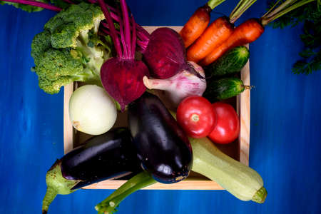 Fresh Vegetables in box on blue wooden backgroundの写真素材