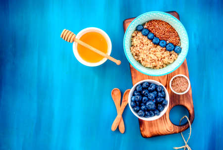 Buckwheat porridge in a bowl with flax seeds and blueberries. oncept healthy food, detox, dietの写真素材