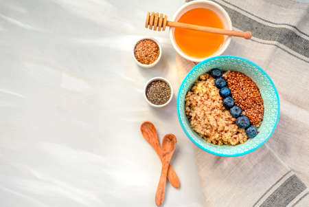 Buckwheat porridge in a bowl with flax seeds and blueberries. oncept healthy food, detox, diet