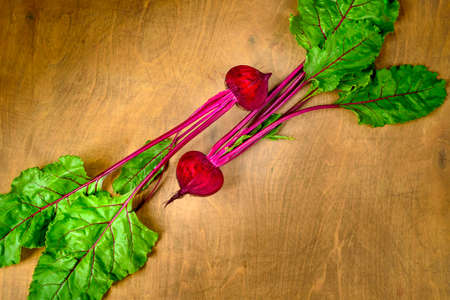 Beet, beetroot bunch on brown wooden background.