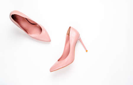 Pale pink female shoes on white background. Flat lay, top view trendy fashion feminine background. Beauty blog concept.の写真素材