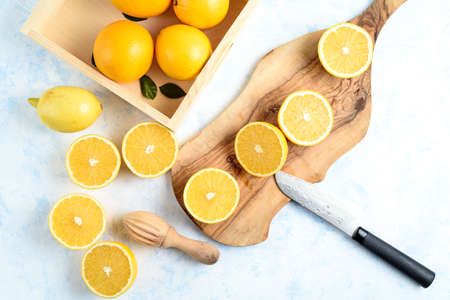Fresh oranges on the kitchen board on tableの写真素材