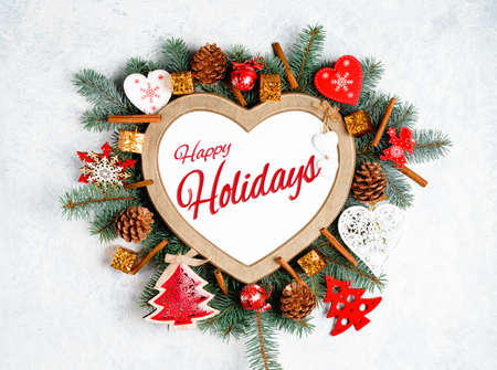 Happy Holidays Text with Holiday Evergreen Branches and Berries in Corner Over Rustic Woodenの写真素材