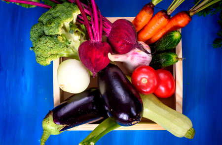 Fresh Vegetables in box on blue wooden backgroundの写真素材