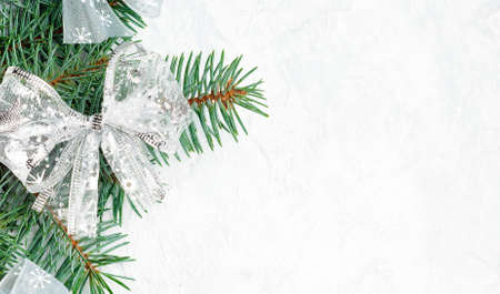 Christmas composition. Christmas gift, knitted blanket, pine cones, fir branches on wooden white