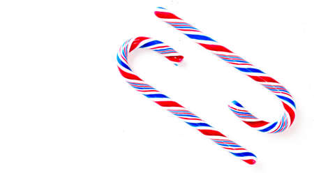 Candy canes on a white surface, top view