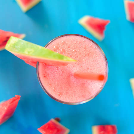 Glass of watermelon smoothie on a wooden table. Selective focus