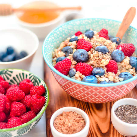 High protein healthy breakfast, buckwheat porridge with blueberries, raspberries, flax seeds and honey Closeup viewの写真素材