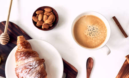 Cappuccino or latte with frothy foam, blue coffee cup top view closeup isolated on whiteの写真素材