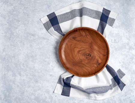 The brown wooden plate on a rustic table closeup. horizontal top viewの写真素材
