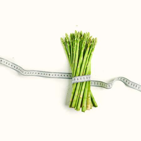 Asparagus with measuring tape concept dietの写真素材