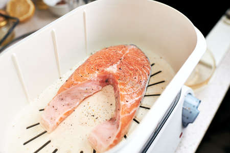 Cooking process, salmon in a double boiler, steamed.の写真素材