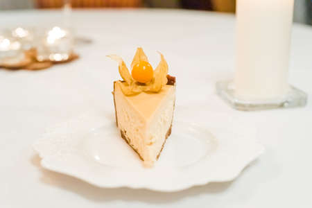 New York cheesecake garnished with physalis on a colorful background