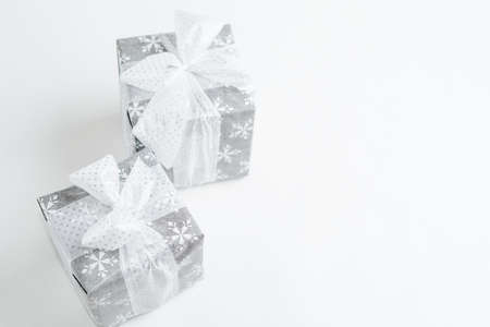 Christmas gift box with festive decoration in silver toneの写真素材