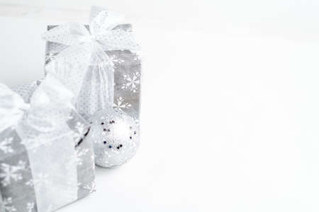 Christmas gift box with festive decoration in silver toneの写真素材
