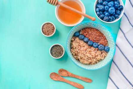 Buckwheat porridge in a bowl with flax seeds and blueberries.の写真素材