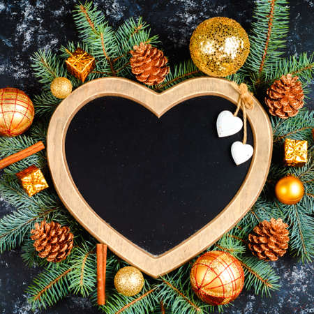 Old paper border with Christmas decorations on wooden backgroundの写真素材