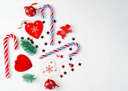 creative arrangement of bright red christmas tree made of christmas ball, sweets, toys on white background. flat lay, top viewの写真素材