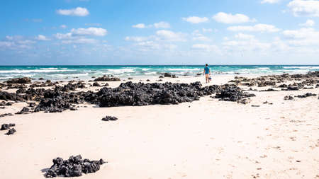 freedom concept, a man walks along the beach on the island of Fuerteventura Spainの写真素材