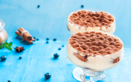 luxury tiramisu dessert in a cocktail glass decorated with cocoa on the wooden backgroundの写真素材