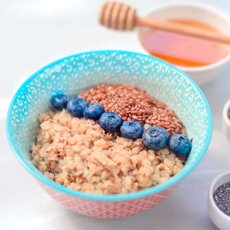 buckwheat porridge with fruits and honey, chia seeds, flax seeds, the concept of a healthy breakfast, diet, veganismの写真素材