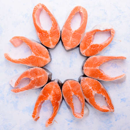 fresh uncooked red fish fillet over whiteの写真素材