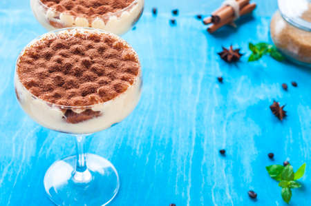 luxury tiramisu dessert in a cocktail glass decorated with cocoa on the wooden backgroundの写真素材