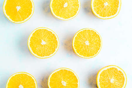 halves of oranges sliced for making orange juiceの写真素材