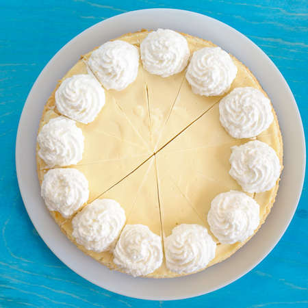 classic cheesecake on a white plate, decorated with creamの写真素材