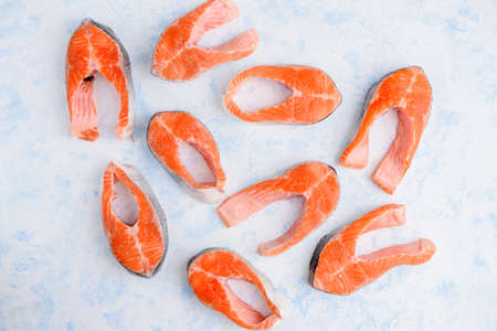 raw salmon steaks pattern on a blue background top viewの写真素材
