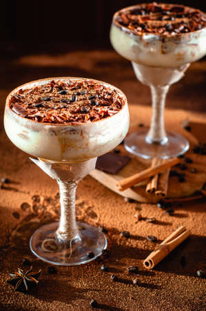 italian dessert tiramisu in an elegant cocktail glass, the concept of sweet life, luxury foodの写真素材