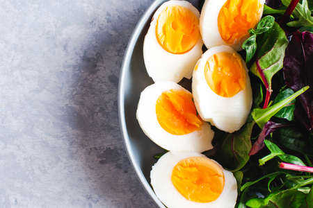 salad with arugula, spinach, tomatoes and eggs tintingの写真素材