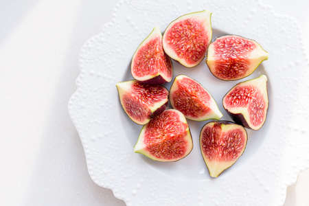 chopped figs on a white ceramic plateの写真素材