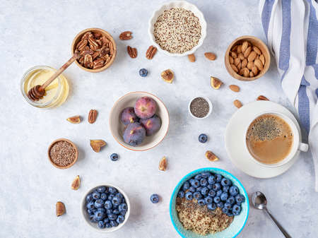 Healthy breakfast of superfoods, quinoa, honey, nuts, figs, coffee. Top viewの写真素材