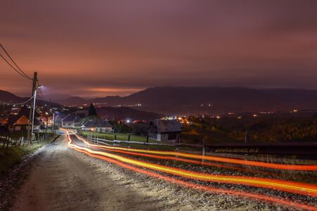 Light trails in a mountain villageの写真素材