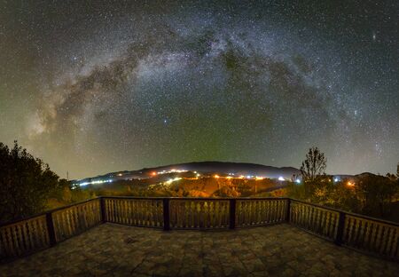 Milky way over the Pestera village in Piatra Craiului mountains from Romaniaの写真素材