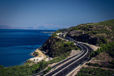 highway on the edge of a cliff and the sea under thatの写真素材