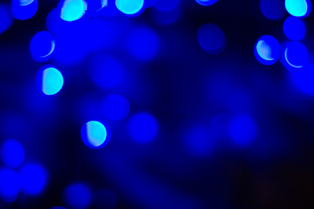 abstract blue bokeh out of focus background on a dark roomの写真素材