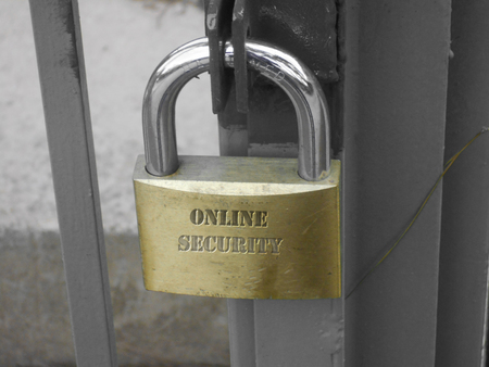 lock with the words onlne security carved on the metal on a closed gate