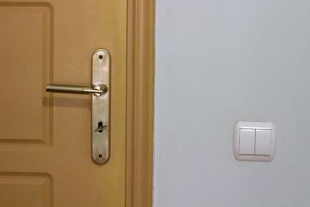 door knob key and a light switch background white wallの写真素材