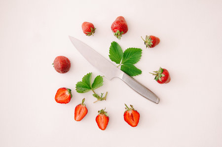 Fresh red strawberry fruit, leaf and knife on white background. Top view, flat lay.の写真素材