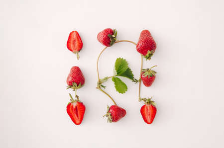 Fresh red strawberry fruit and leaf on white background. Top view, flat lay.の写真素材