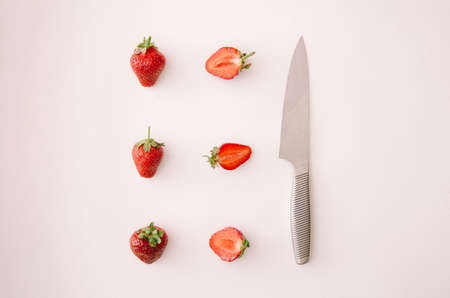 Fresh red strawberry fruit, leaf and knife on white background. Top view, flat lay.の写真素材