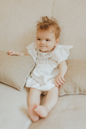 Cute little girl on the couchの写真素材