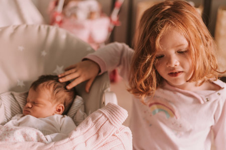 Big sister with her little newborn sisの写真素材