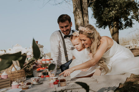 Cute family moment at the park after weddingの写真素材